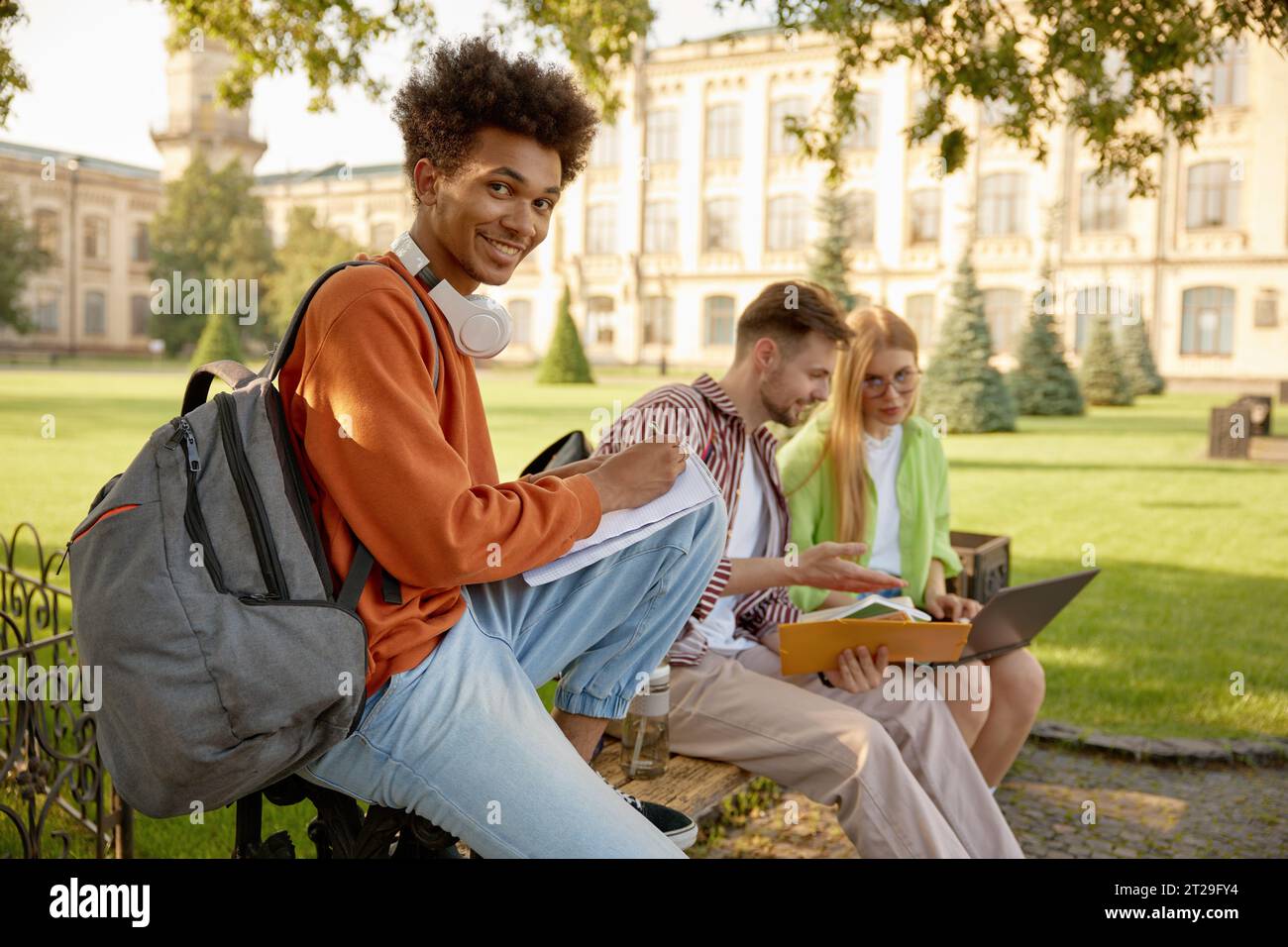 University students working on homework or creative project at campus outdoors Stock Photo