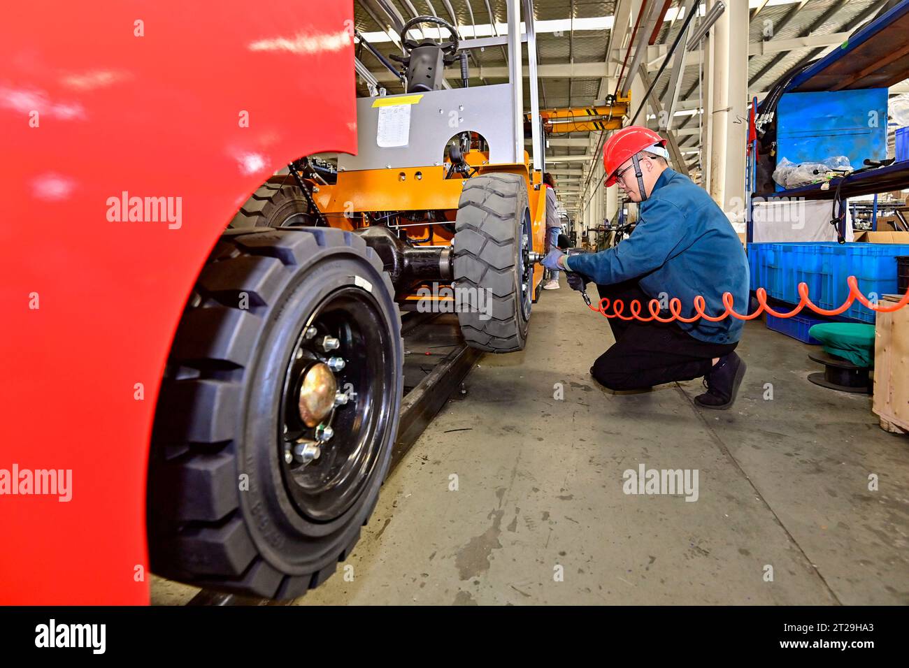 QINGZHOU, CHINA - OCTOBER 18, 2023 - A worker assemses an electric ...