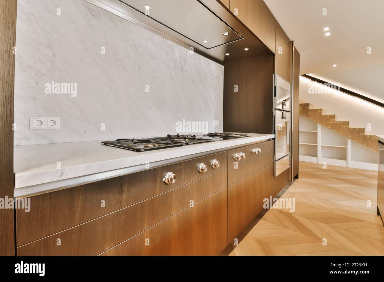 Interior of contemporary kitchen with stove on marble countertop and ...