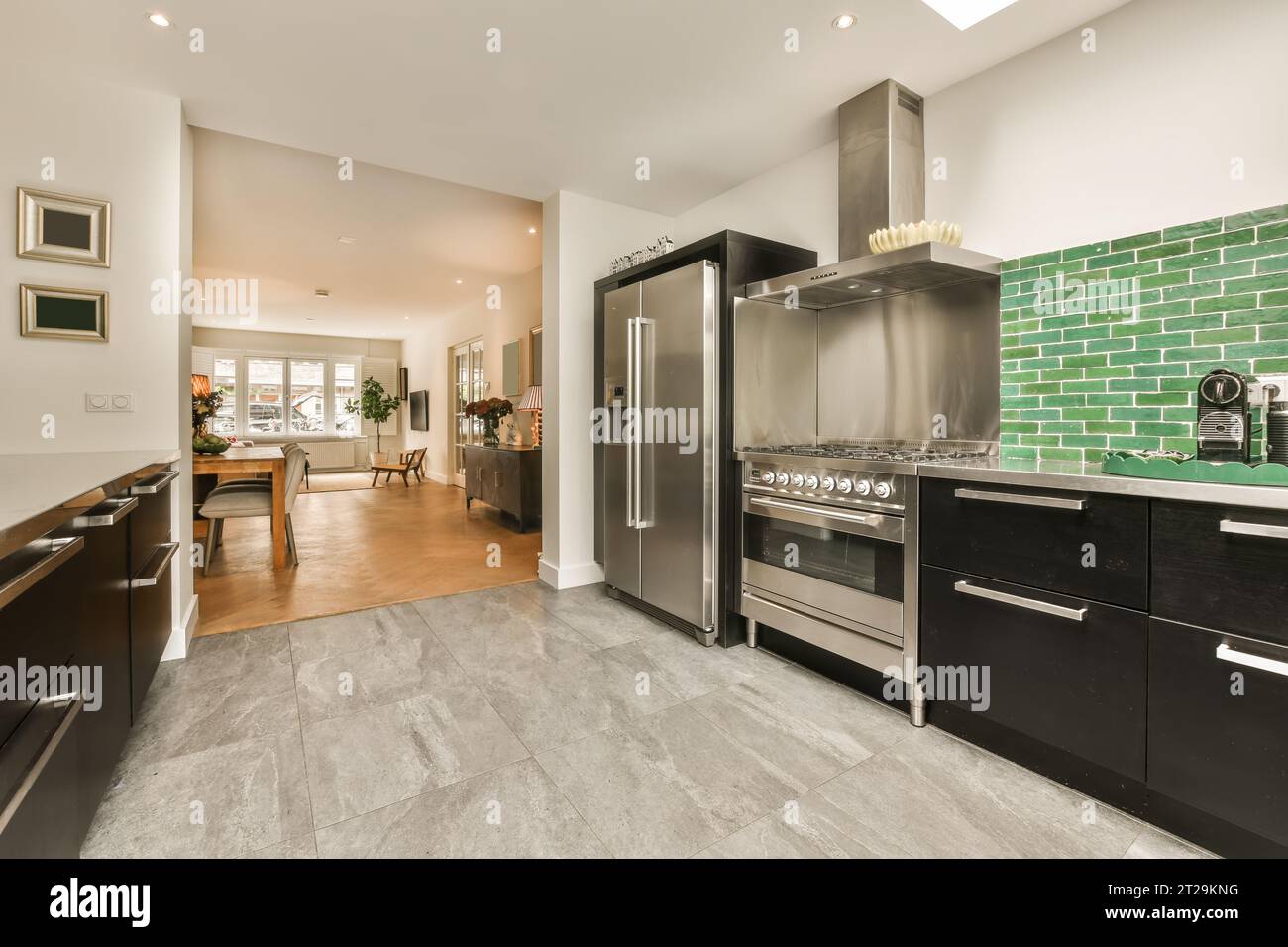Interior of kitchen with modern stainless steel appliances and black ...