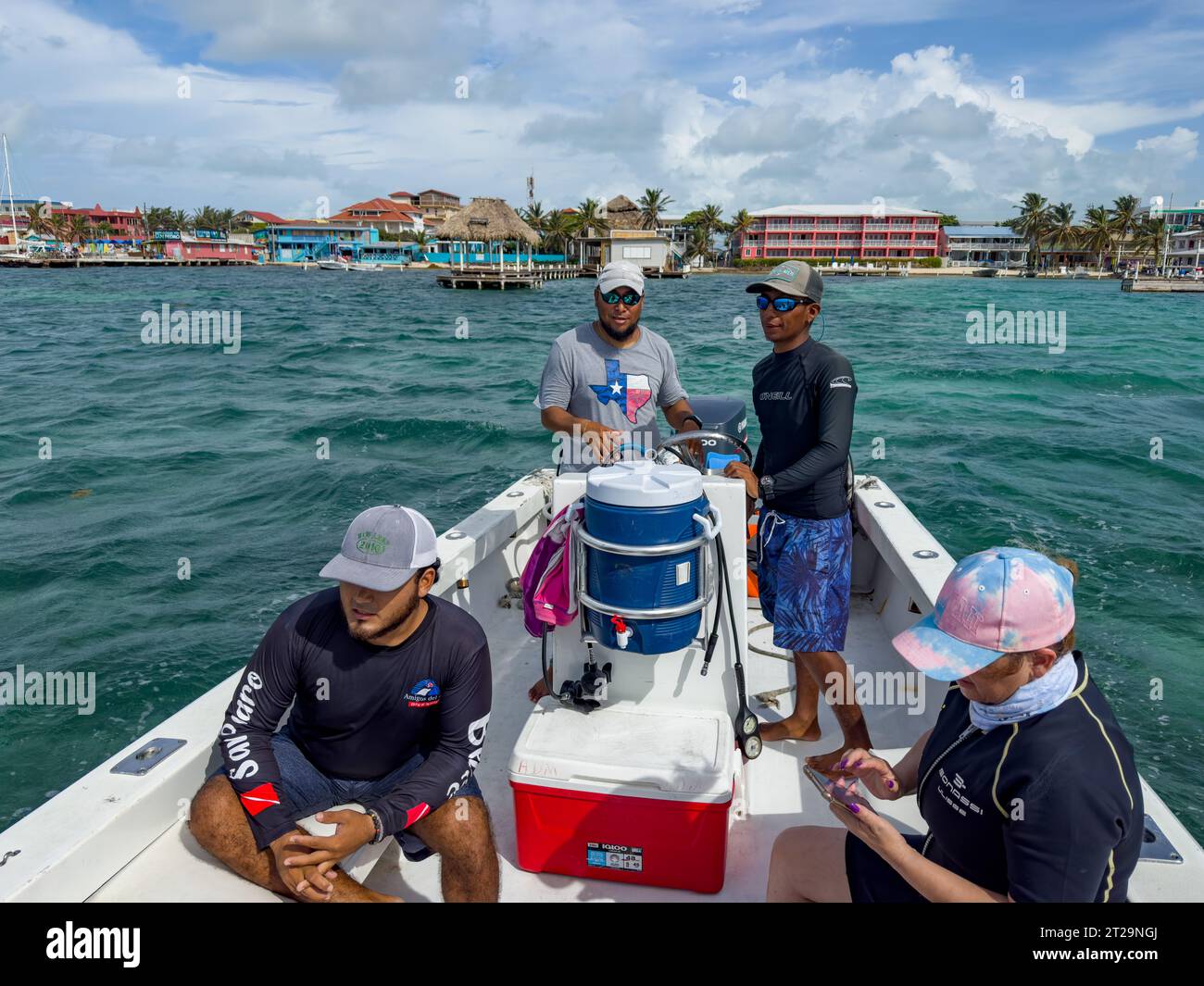 Dive guides & female tourist on a snorkeling trip to the Hol Chan