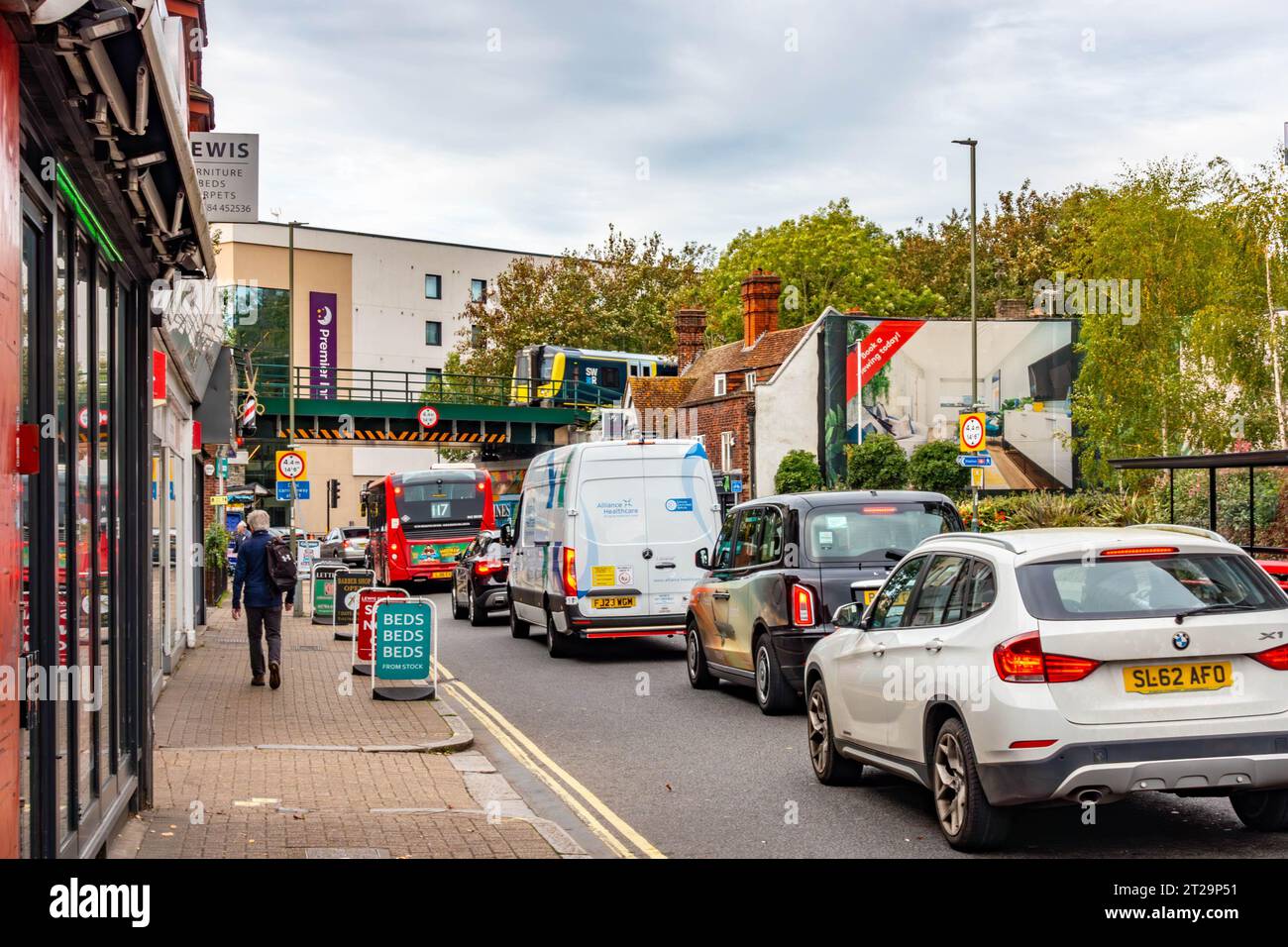 Traffic on the A308 High Street passes under the Iron Bridge railway