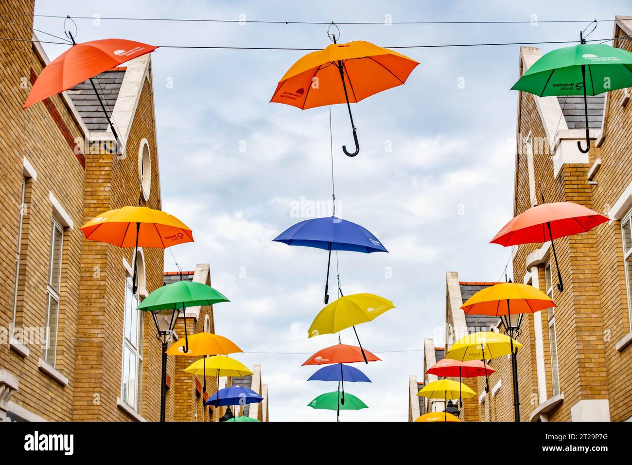 Colourful, decorative umbrellas hang overhead along Norris Road in