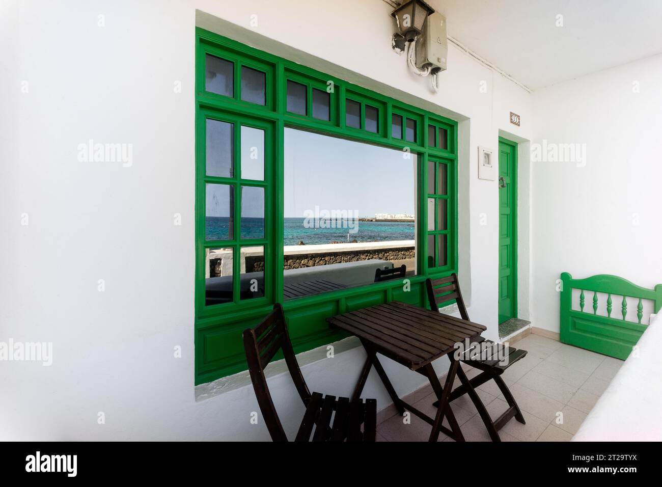Lanzarote, Punta Mujeres: house with mirrored windows on the seafront in Arrieta Stock Photo