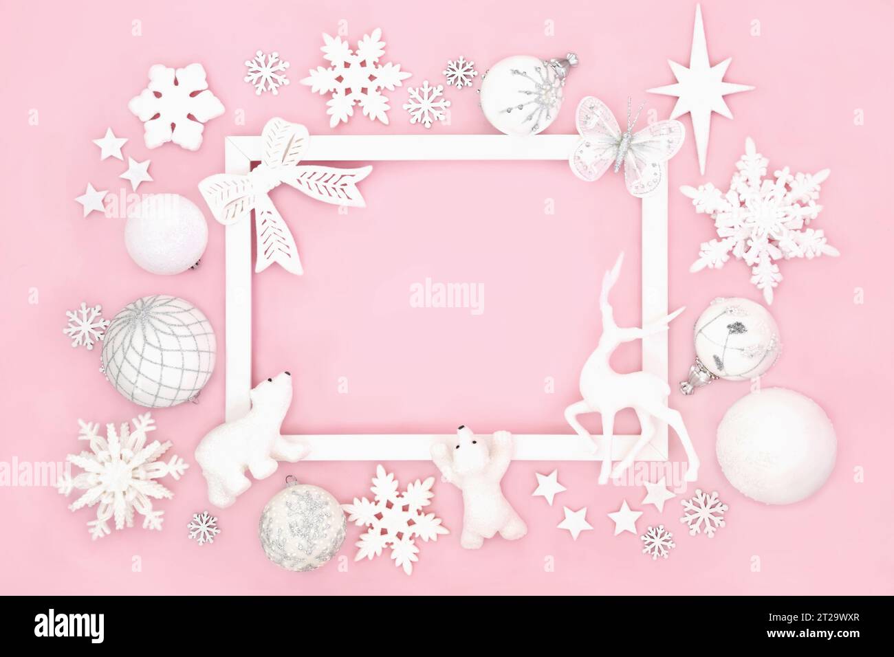 Christmas north pole themed background border of sparkling decorations with white frame. Festive