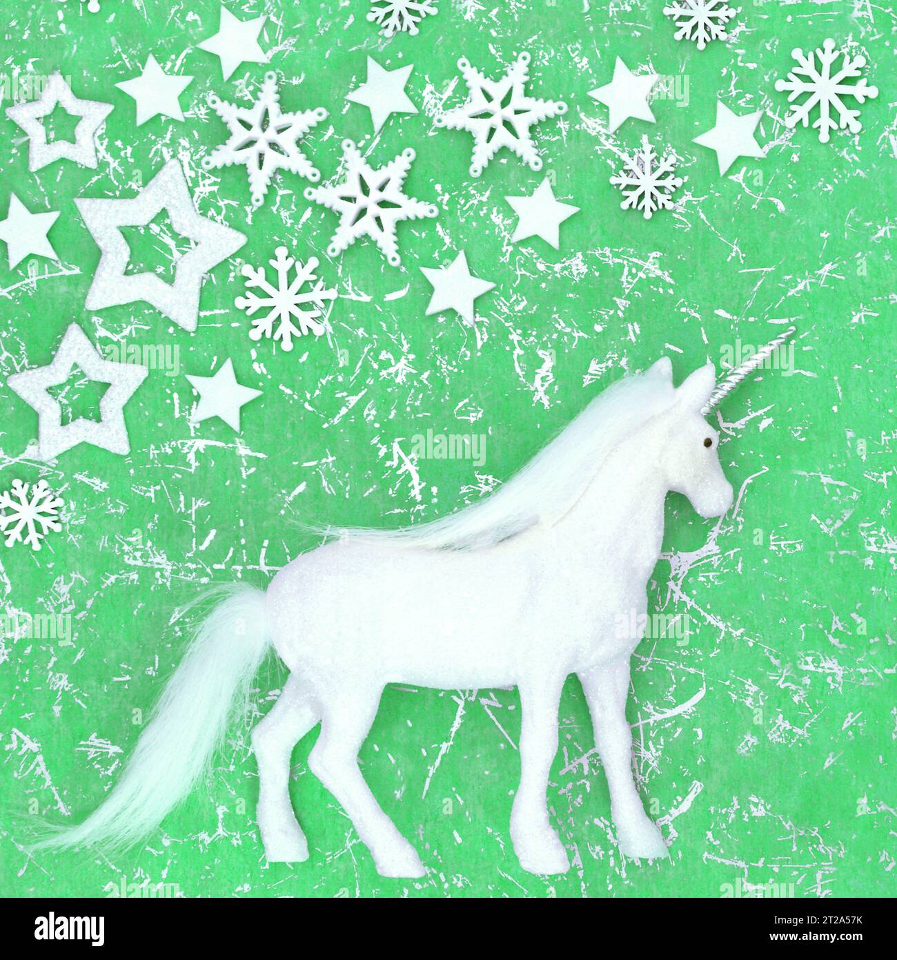 Christmas unicorn magical fantasy decoration with snowflake and star decorations on mottled 