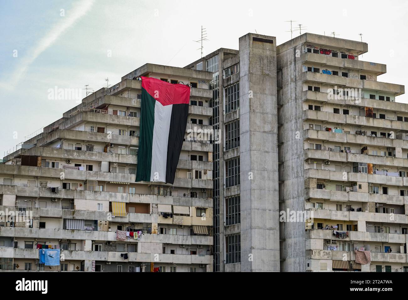 Napoli, Italy. 18th Oct, 2023. A large flag of about 30 metres with the colours of Palestine was displayed for a few minutes on the Vele in Scampia, at the initiative of activists of the Network for Palestine. About forty activists were present. The flag was displayed for a few minutes and then removed, attracting the attention of passers-by. Credit: Live Media Publishing Group/Alamy Live News Stock Photo