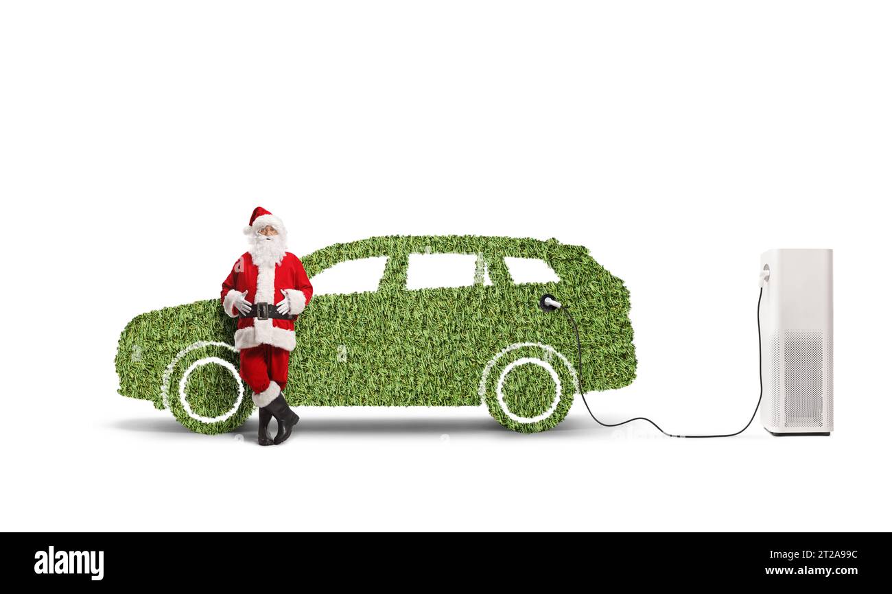 Santa claus leaning on a green car at a charging station isolated on white background Stock Photo
