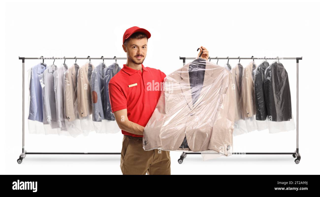 Dry cleaning worker holding a suit in a plastic bag cover in front of