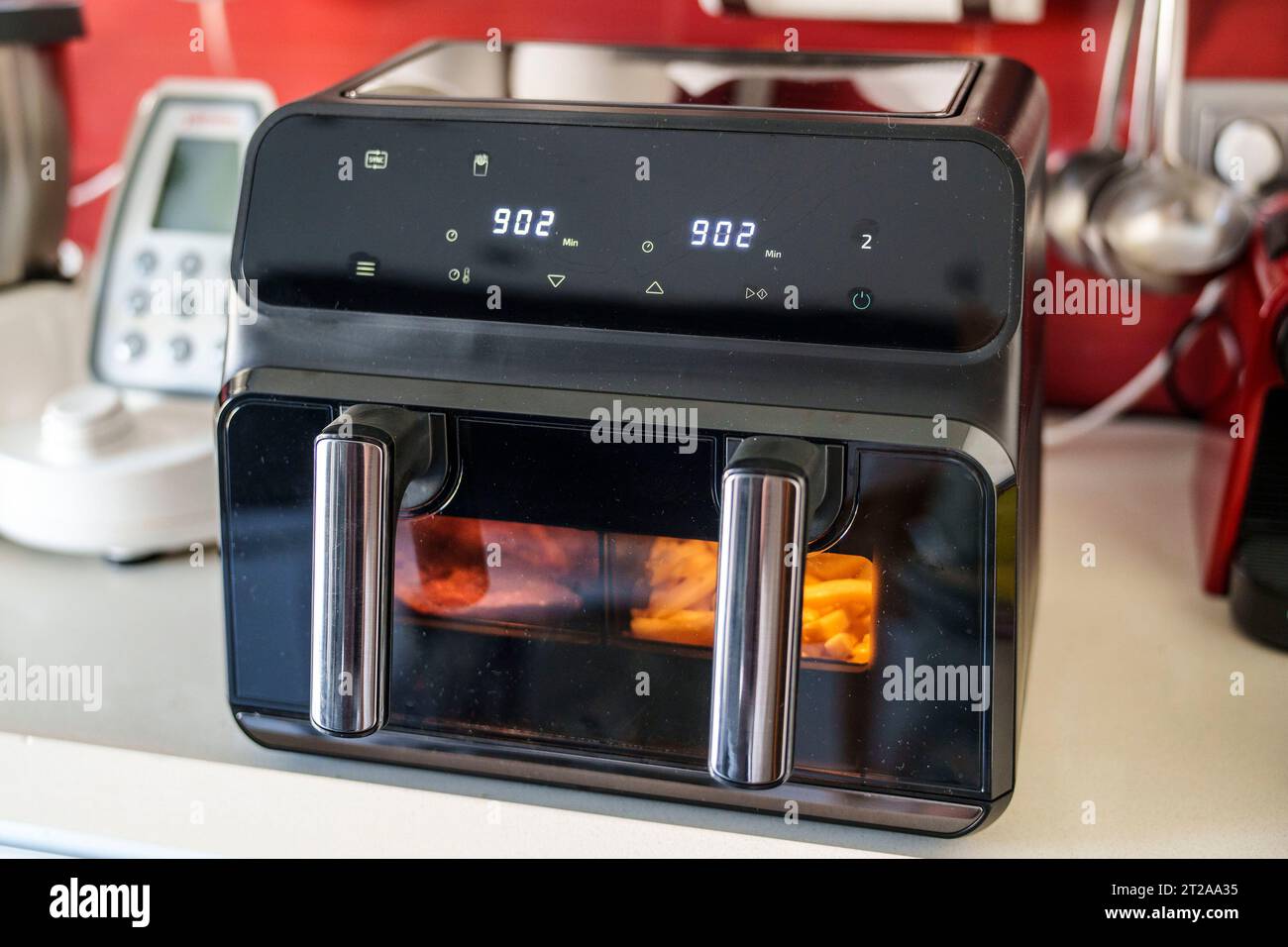 Large double tray air fryer on a kitchen countertop Stock Photo