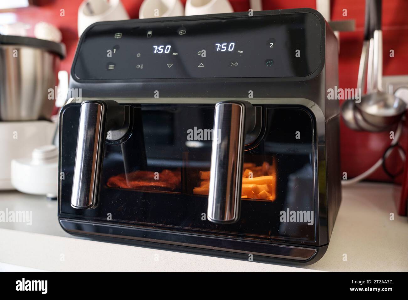 Large double tray air fryer on a kitchen countertop Stock Photo