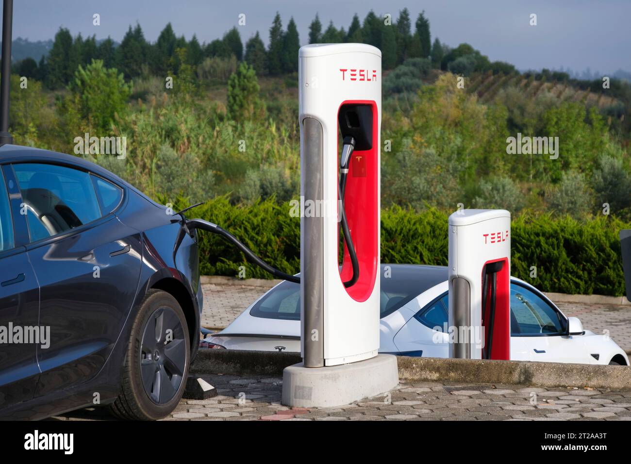 Two Tesla model 3 electric cars rapid charging at the Tesla supercharger SUC in Mealhada, Portugal, Europe Stock Photo