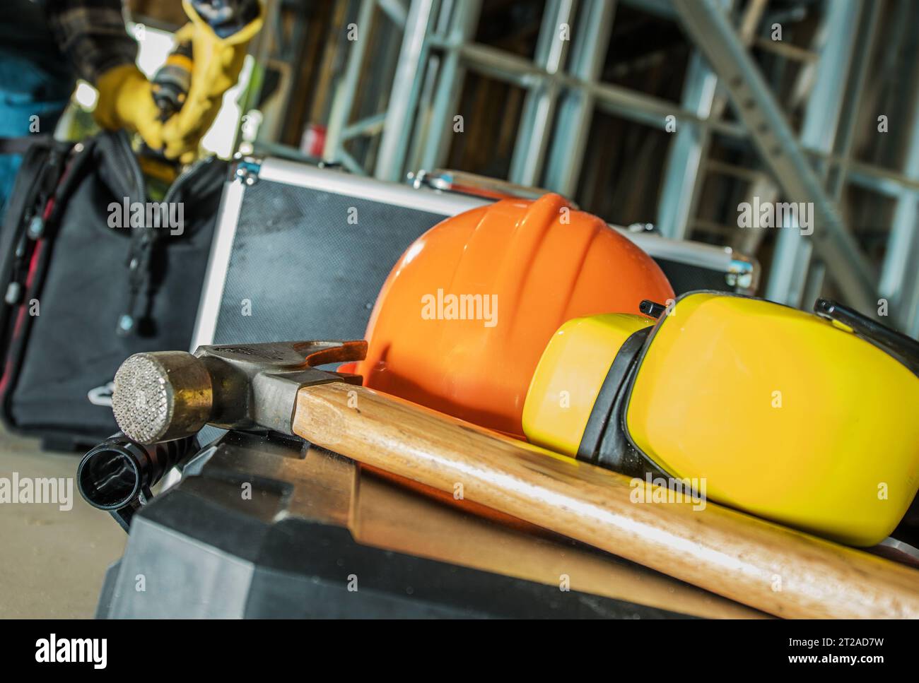 Construction Site Tools and Safety Equipment Like a Hard Hat and Noise Reduction Headphones. Stock Photo