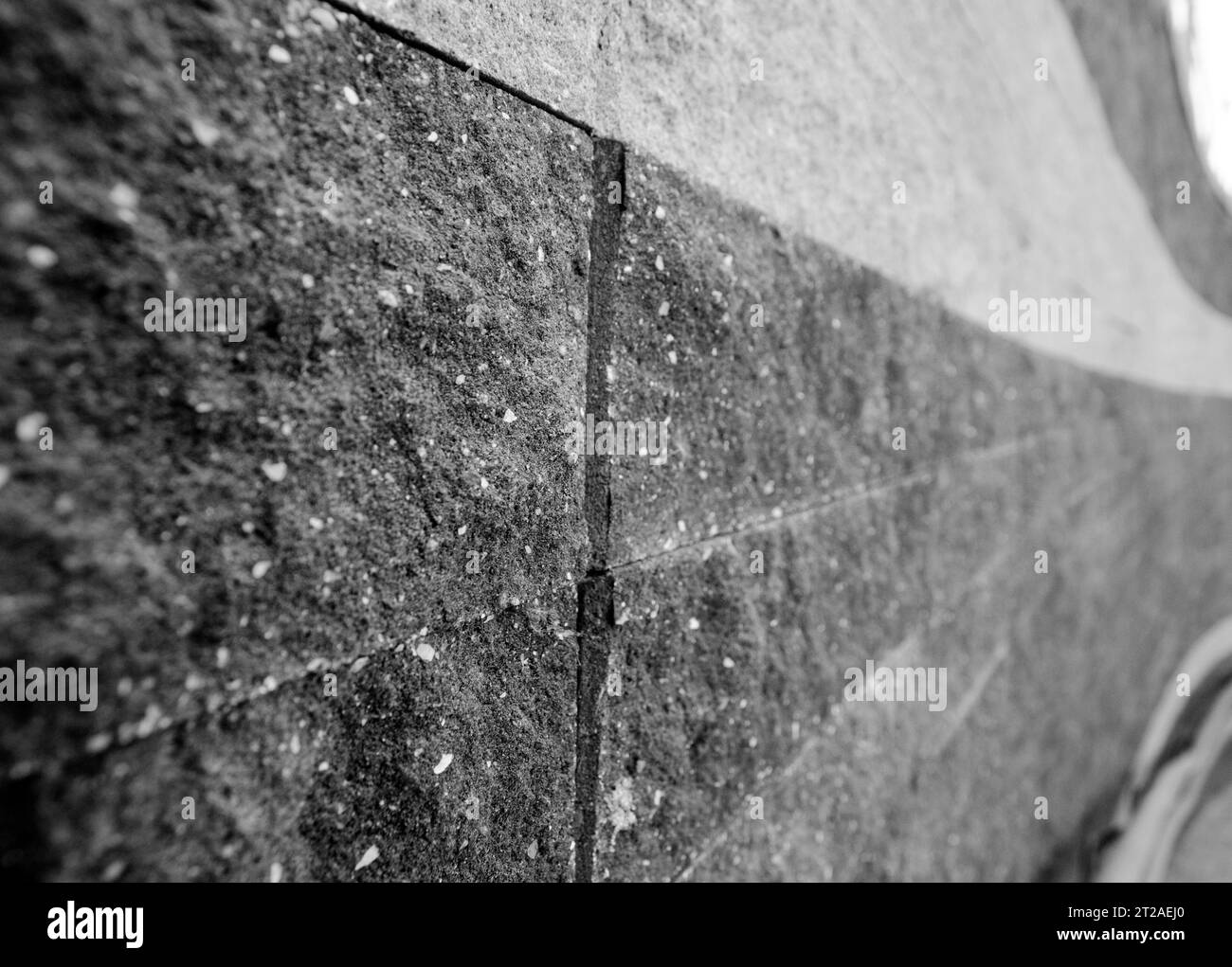 Brick wall turning right black and white photo background, close macro