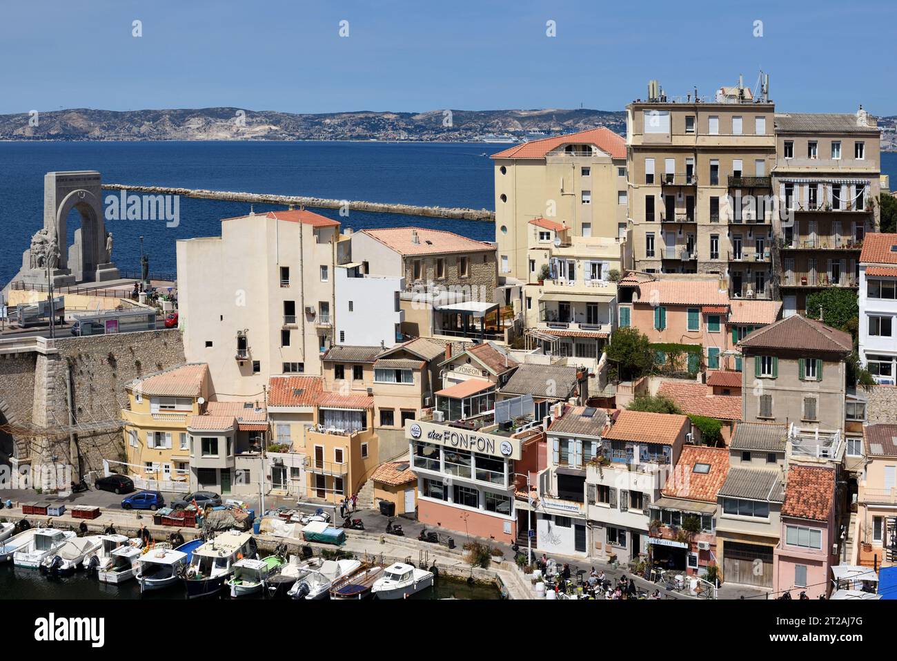 View over the Rooftops of Old Houses or Traditional Town Houses in the Vallon des Auffes with the Bay of Marseille or Mediterranean Behind France Stock Photo