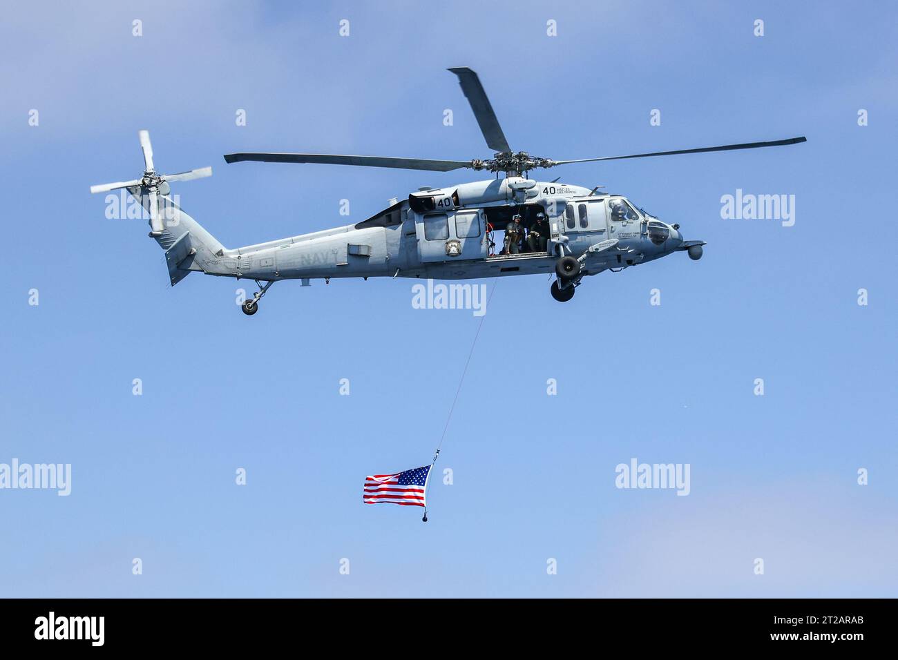 HSC-23 helicopter pilots fly over USS John P. Murtha with an American ...