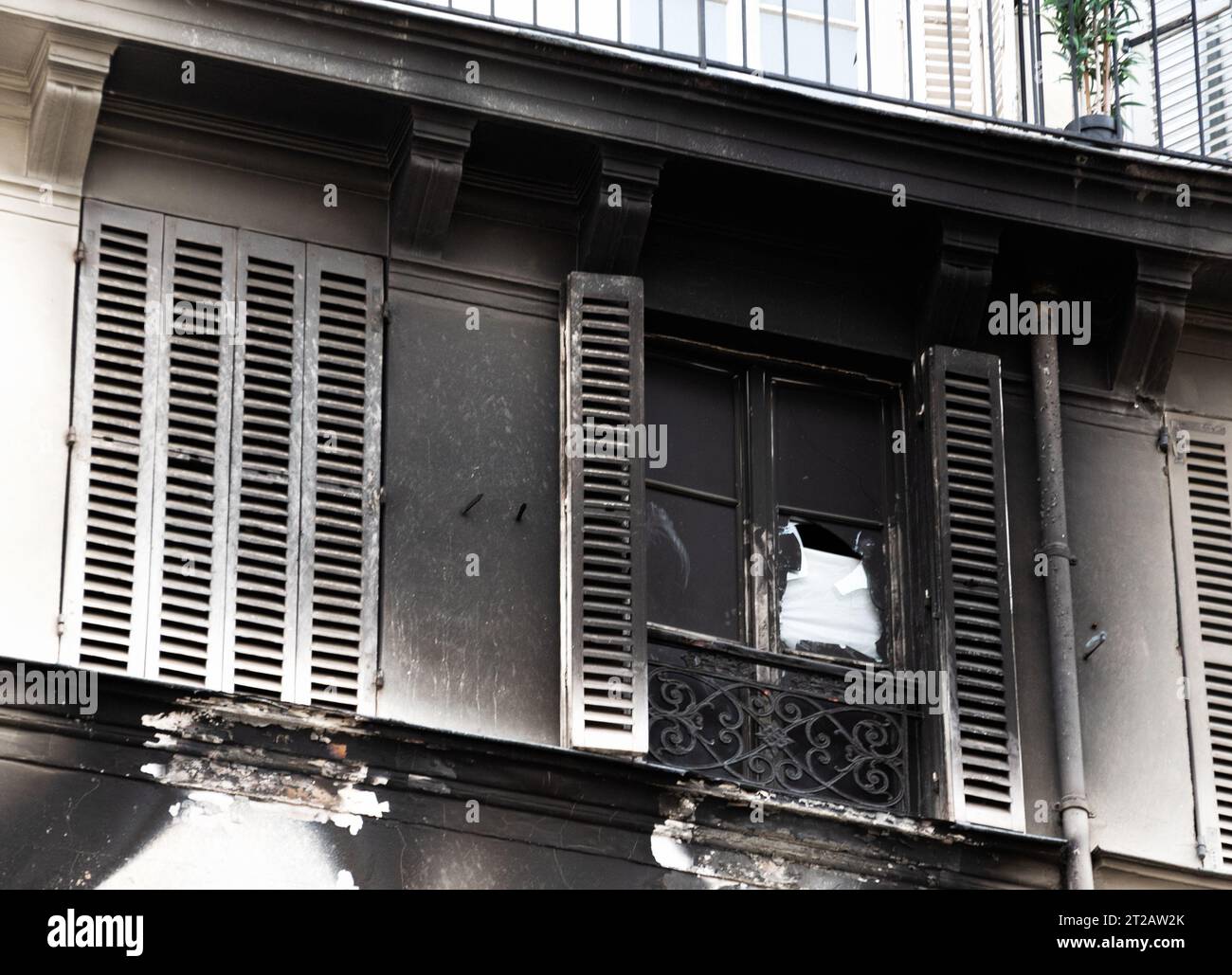 Curated visual reference: Visual Reference: Typical Parisian Building Exterior After Fire Burnt Charred Wall