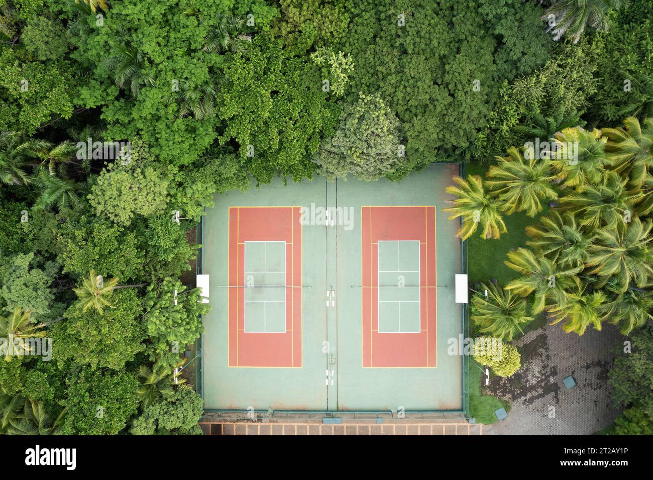 Private tennis court in green park background above top drone view Stock Photo