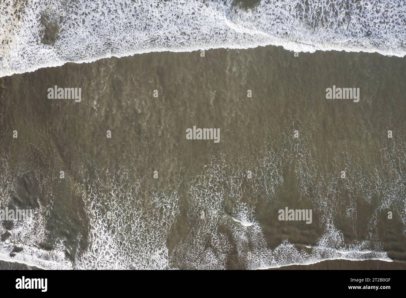 Crashing waves on shore above top drone view texture Stock Photo