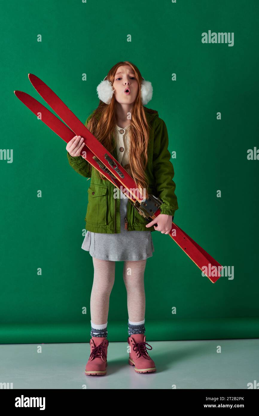 cold air, preteen girl in ear muffs and winter outfit breathing and