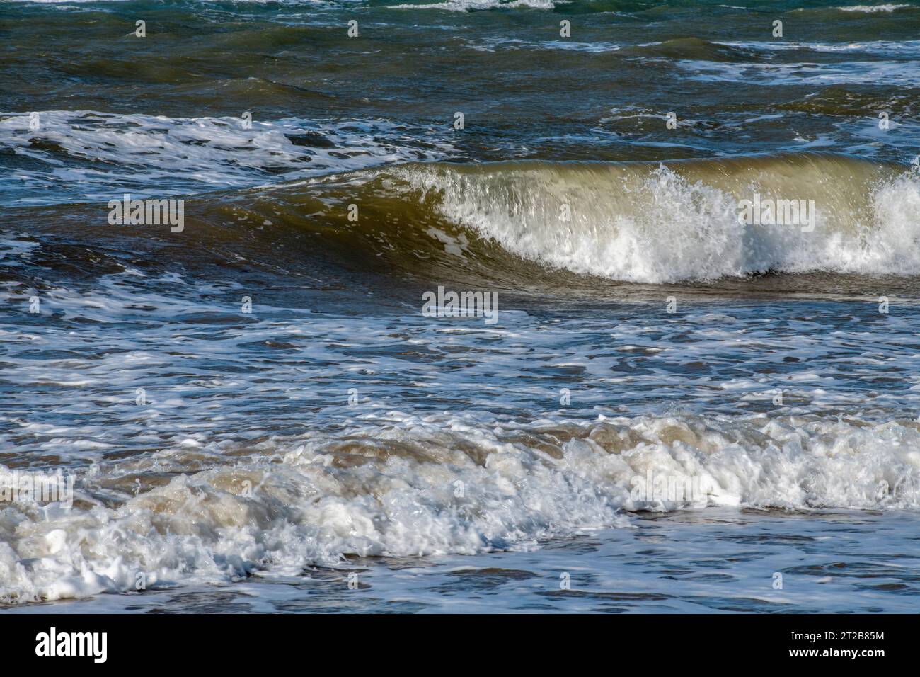 close-up of rough sea with waves breaking on the shoreline. large waves on a stormy day at sea in rough weather. Stock Photo