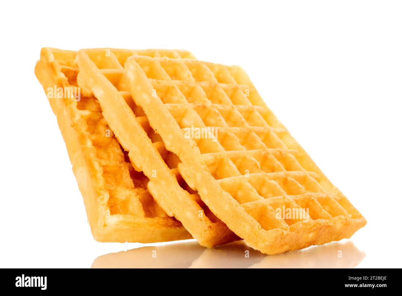 Three freshly baked aromatic waffles, macro, isolated on white