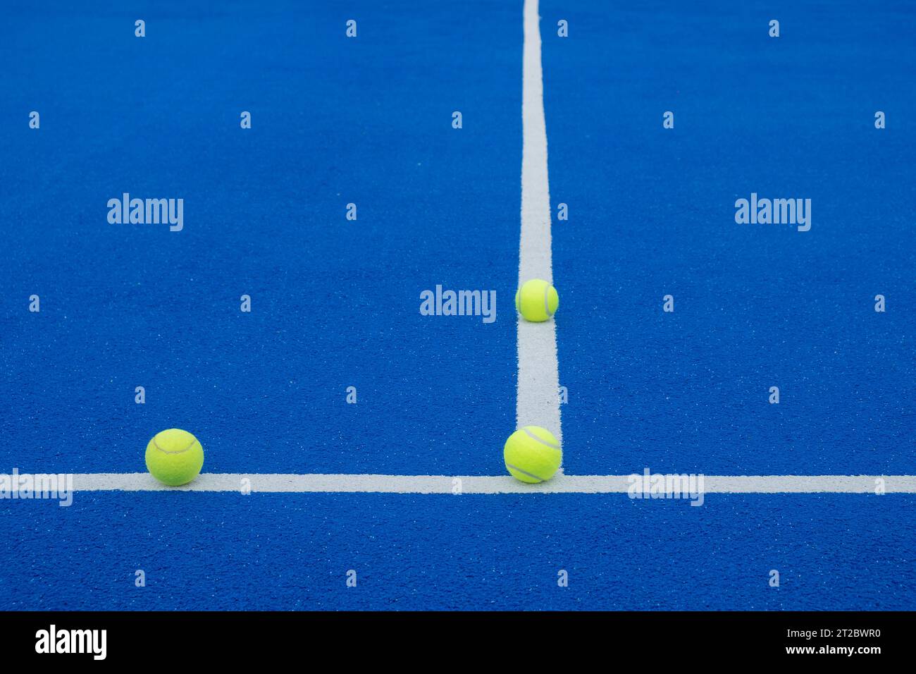three balls on the lines of a paddle tennis court Stock Photo