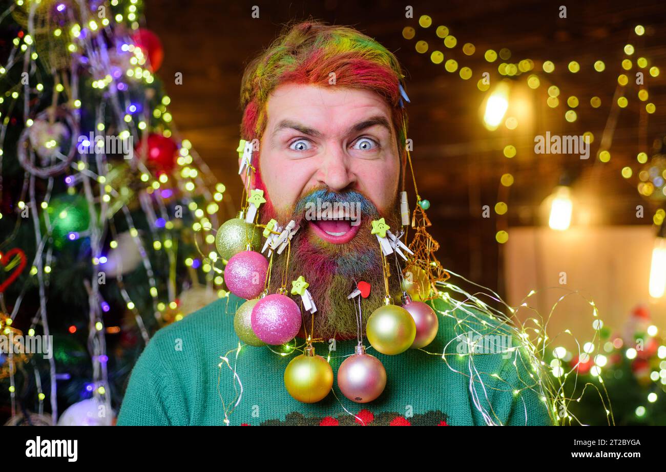 Merry Christmas and Happy new year. Christmas beard decorations. Funny hipster man with beard decorated with Christmas balls. Happy bearded man with Stock Photo