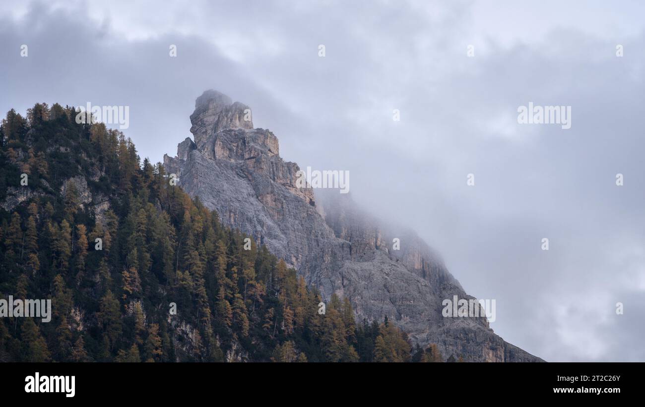 Mountain peak shrouded in fog during autumn season, Italy, Europe Stock Photo