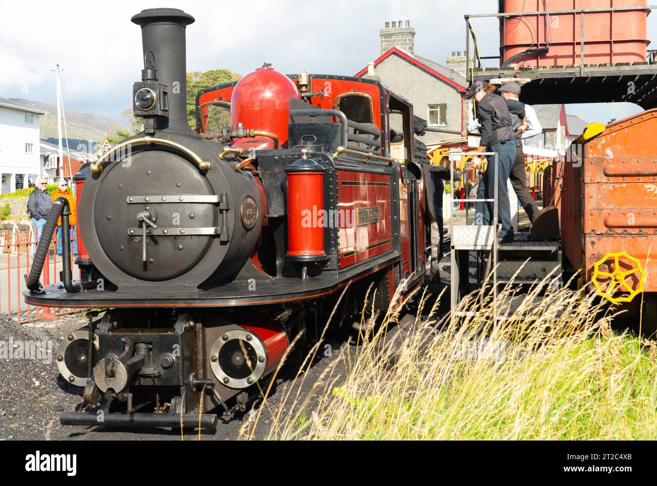 The David Lloyd George steam engine of the Ffestiniog Railway, being refuelled in Porthmadog Harbour Station, in Oct 23. Note the female Stoker. Stock Photo