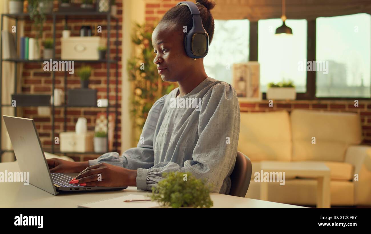 Freelancer works at desk with music, enjoying online job tasks while ...