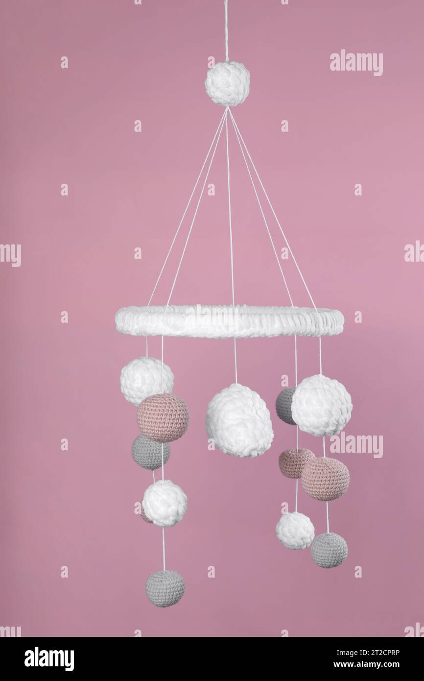 Cute baby crib mobile on pink background Stock Photo Alamy