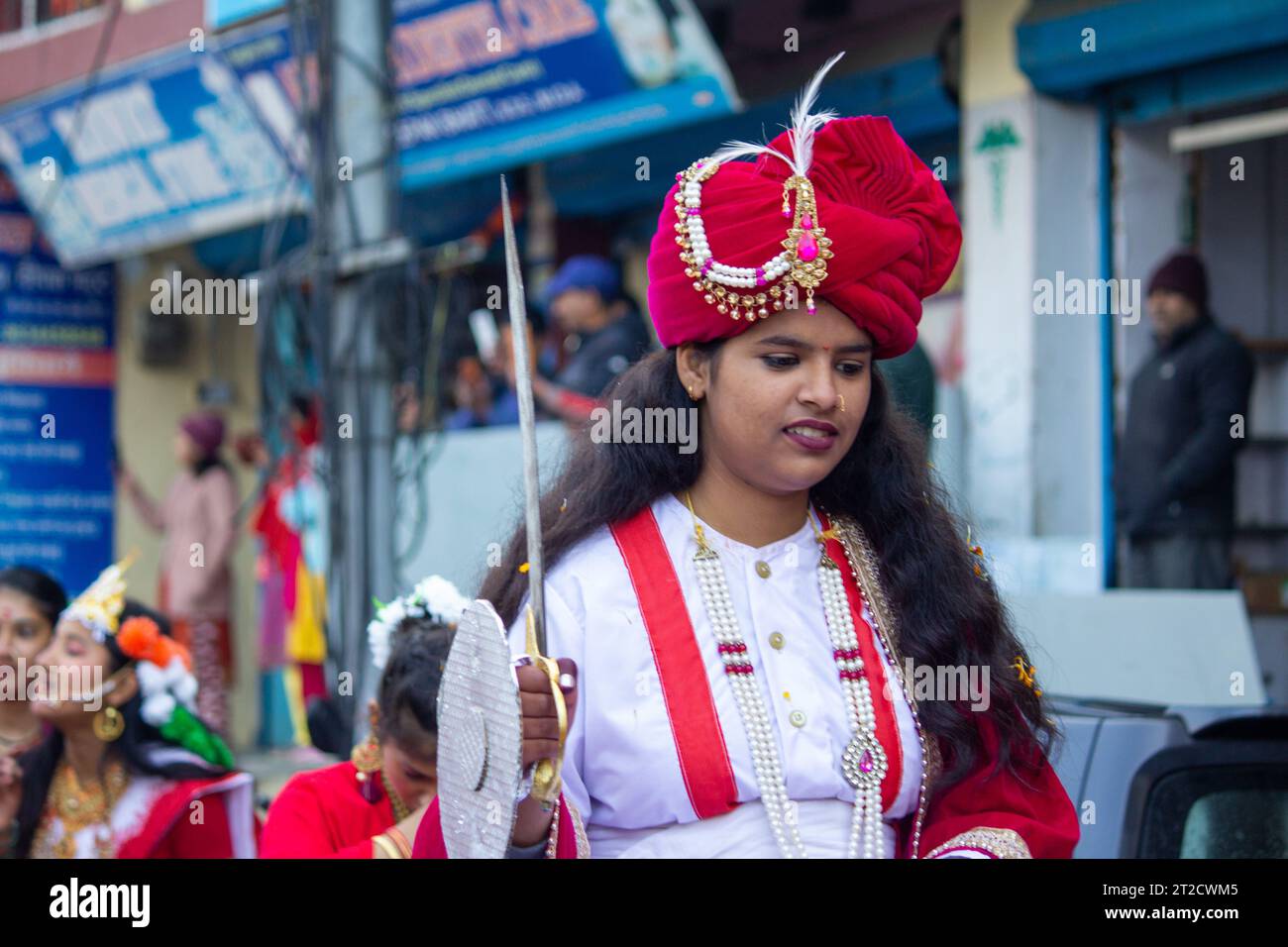 A young girl wearing a traditional costume with an ornamental pearl