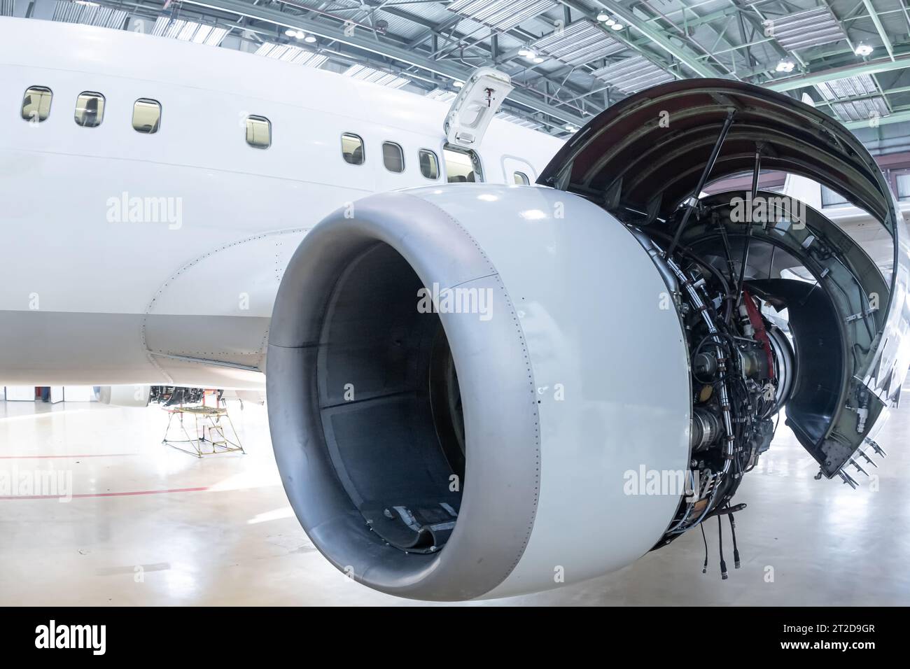 Close-up of an open high bypass turbofan airplane engine of a passenger aircraft in a hangar Stock Photo