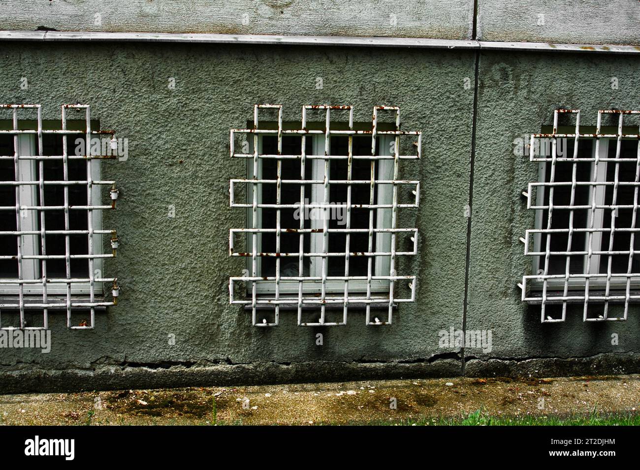 A closeup of windows with grated metal bars in the 20th district