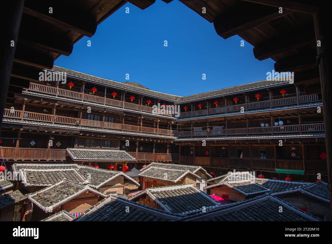 China- Fujian Province- picture of the inner courtyard of a Tulou in a Hakka village. Square Tulou, blue sky with copy space for text Stock Photo