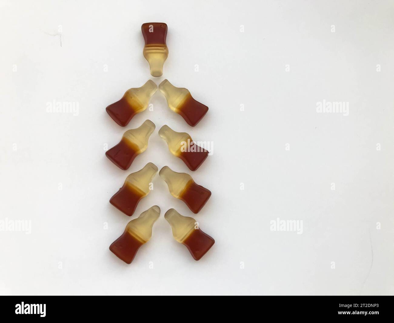 Christmas tree made from gummy bottles with lemonade on a white matte background. delicious and