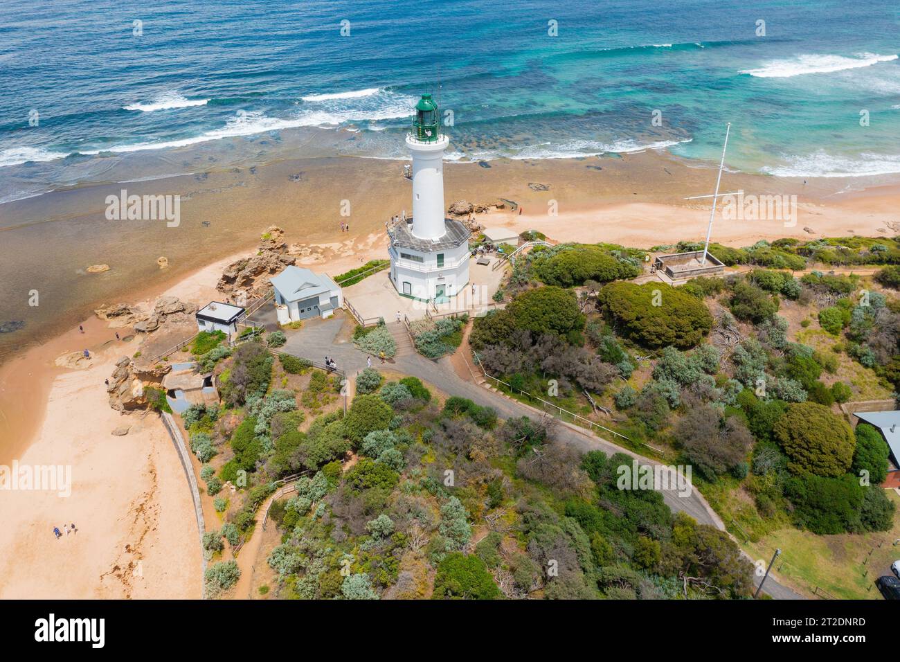 Aerial view of a tall white lighthouse on a cliff top surrounded by sandy beaches at Point Lonsdale on the Bellarine Peninsula in Victoria, Australia Stock Photo