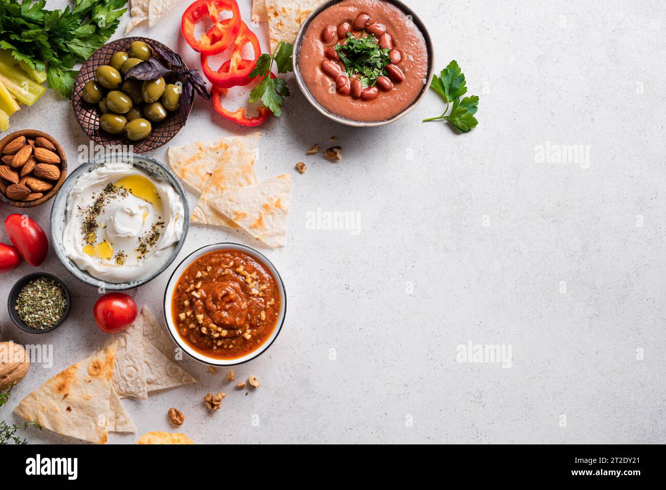Selection of arabic mezze food foul, labneh yogurt, muhamara dip on