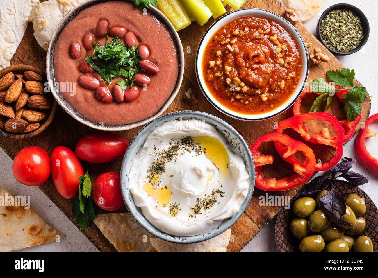 Arabic mezze platter foul, labneh yogurt, muhammara dip with pita