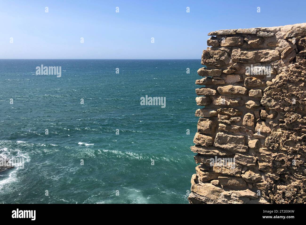 Beautiful coastal landscape with a wall on the right hand side in Ericeira, Portugal Stock Photo