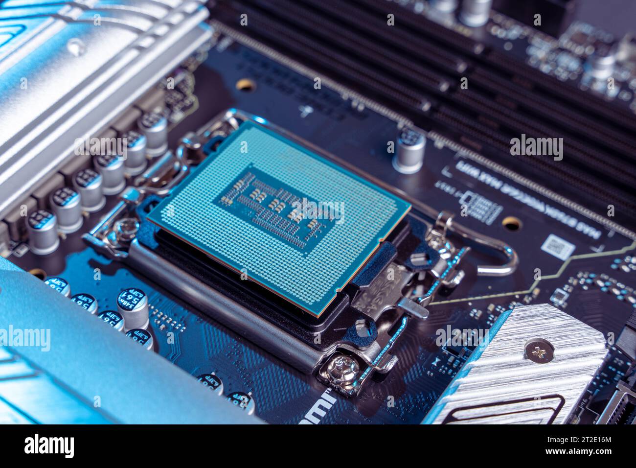 the processor in the motherboard socket is a close-up. modern powerful and fast motherboard with slots for RAM and CPU. the concept of PC hardware. Stock Photo