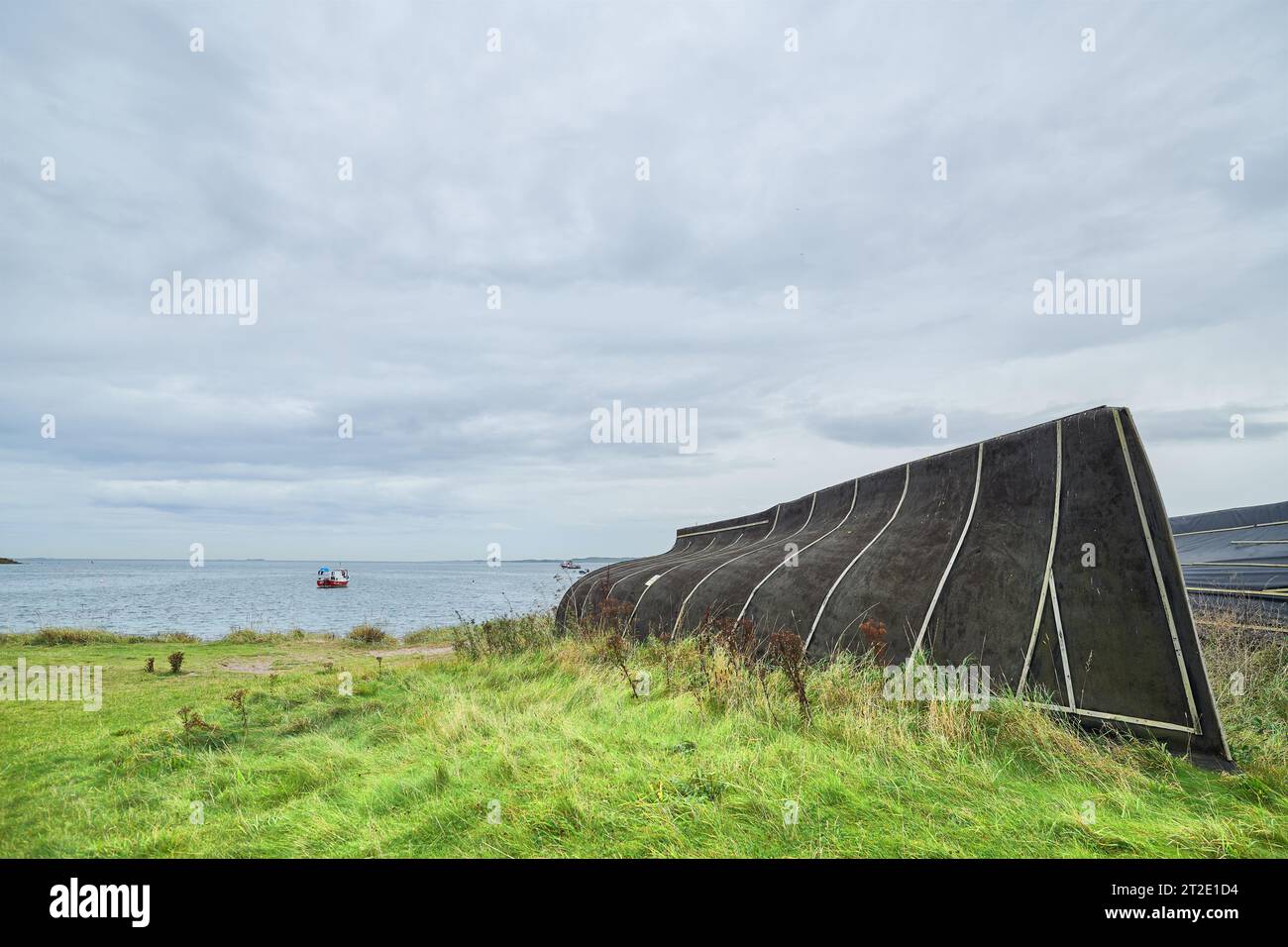 Former herring fishing boat, now upturned and used as a storage shed on