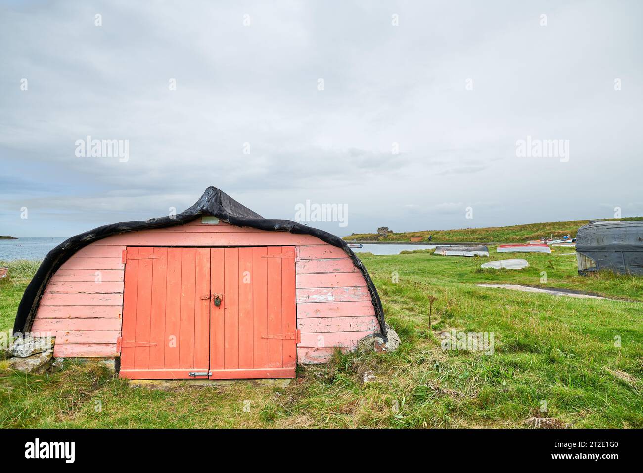 Former herring fishing boat, now upturned and used as a storage shed on