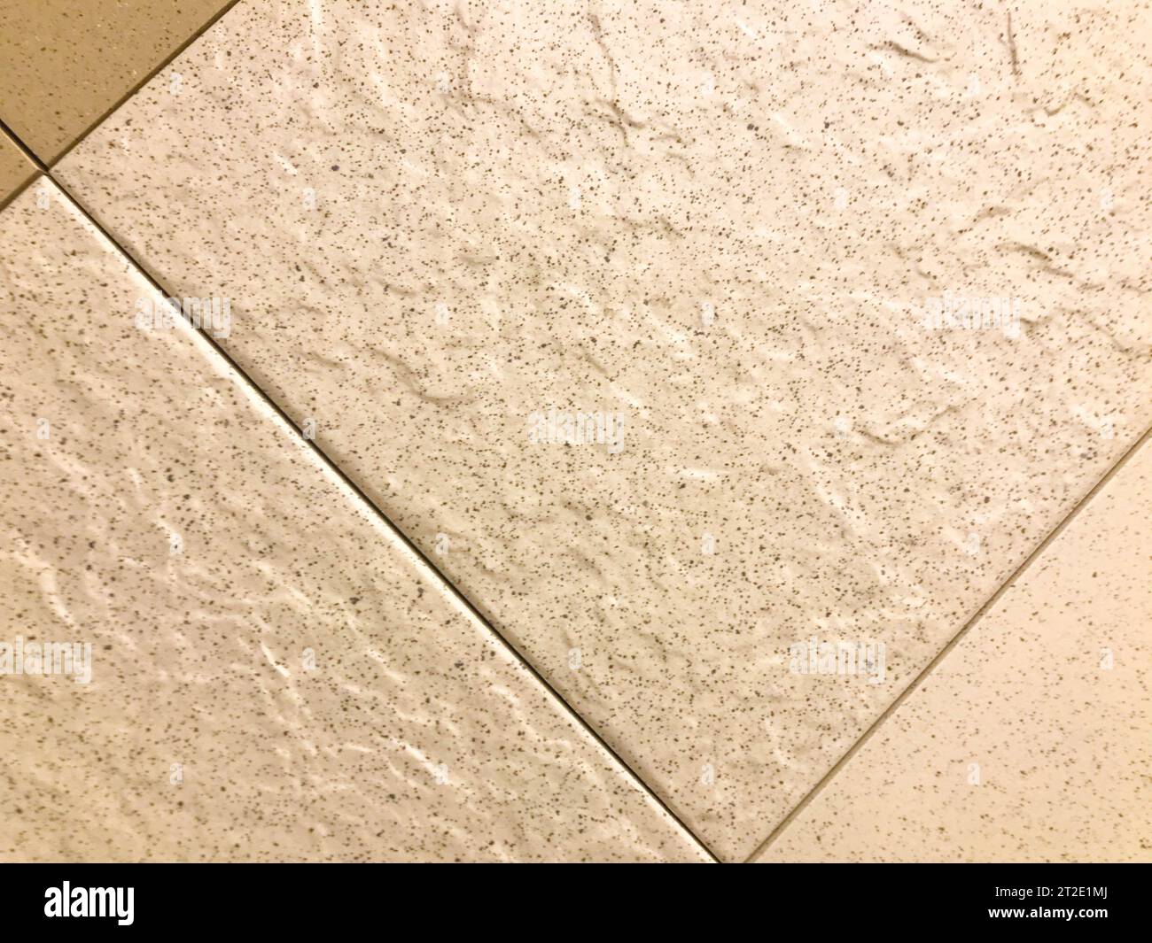 decorative brick for wall covering, texture. white tiled brick, tiled flooring with concrete joints. white floor covering with black spots. Stock Photo