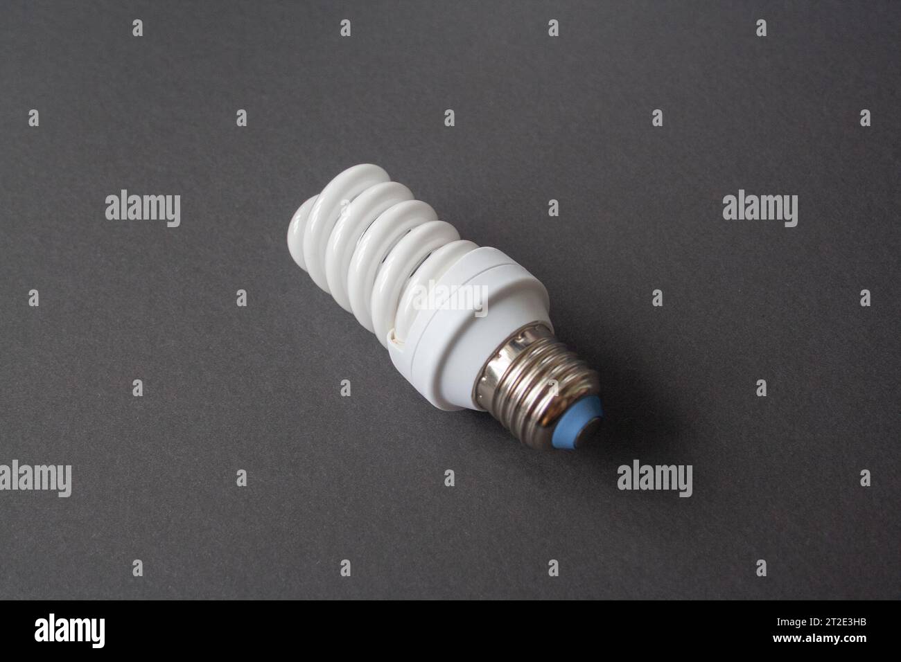 Energy saving light bulb on a black background Stock Photo - Alamy