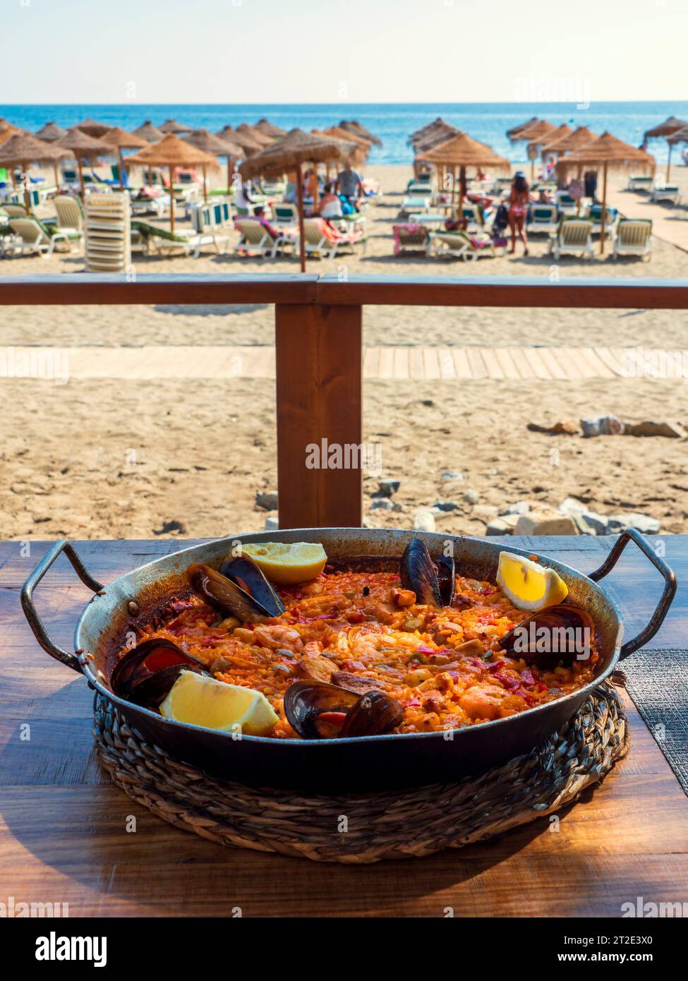 Typical paella dish in front of the beach of Fuengirola Stock Photo