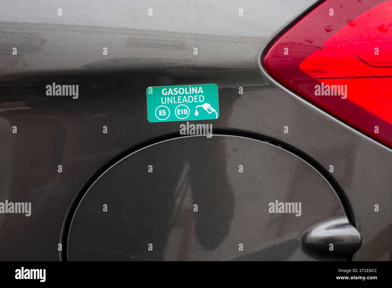 Sticker above fuel cap cover showing which type of fuel required on rental car, Portugal Stock Photo