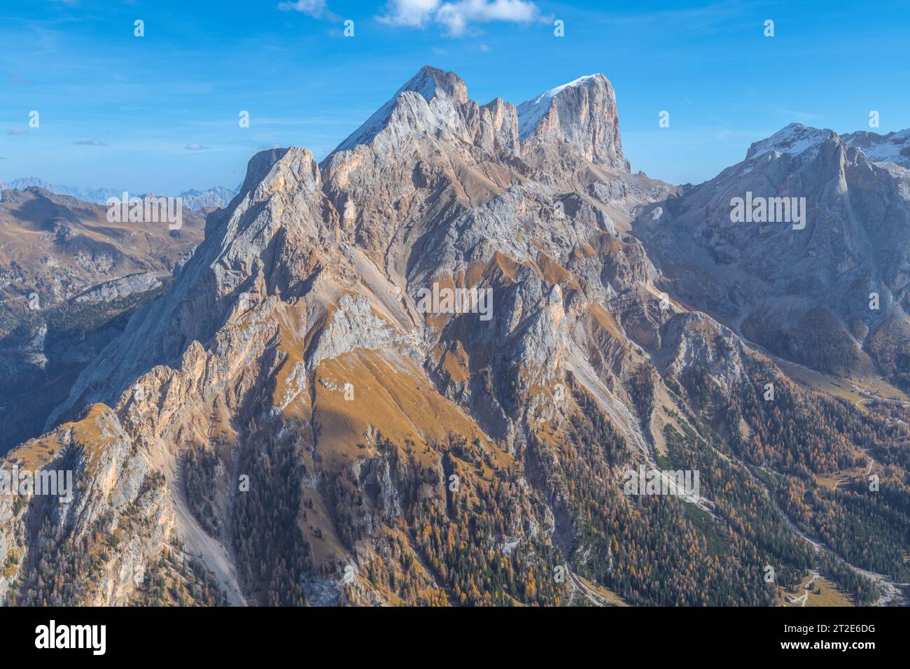 Summit view of the Marmolada massif in the Italian Dolomites. Autumnal vegetation in the grassy slopes and alpine valleys. Stock Photo