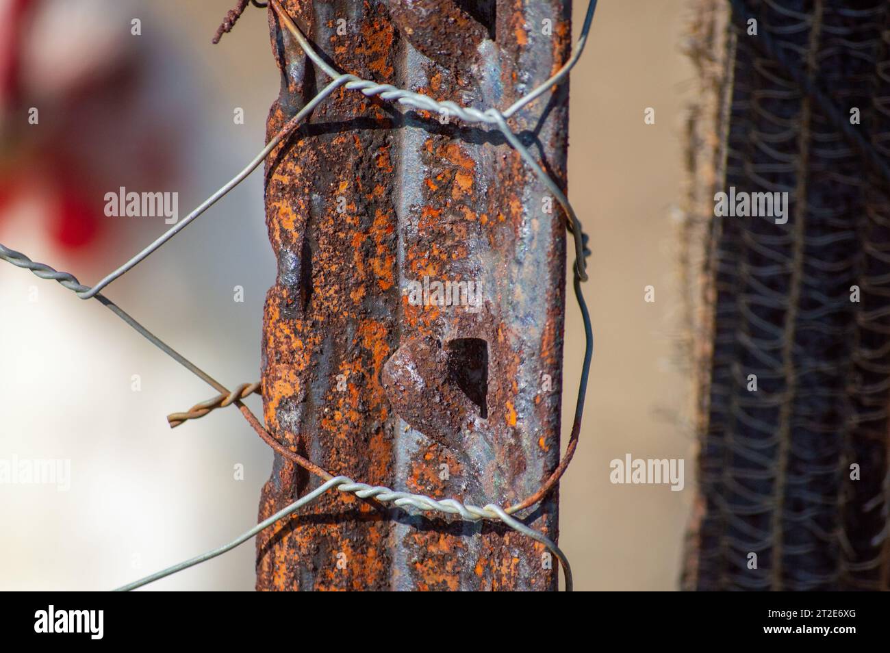 An old fence pole used for a chicken coop. The fence pole shows the effects of weathering and decay on rural structures Stock Photo